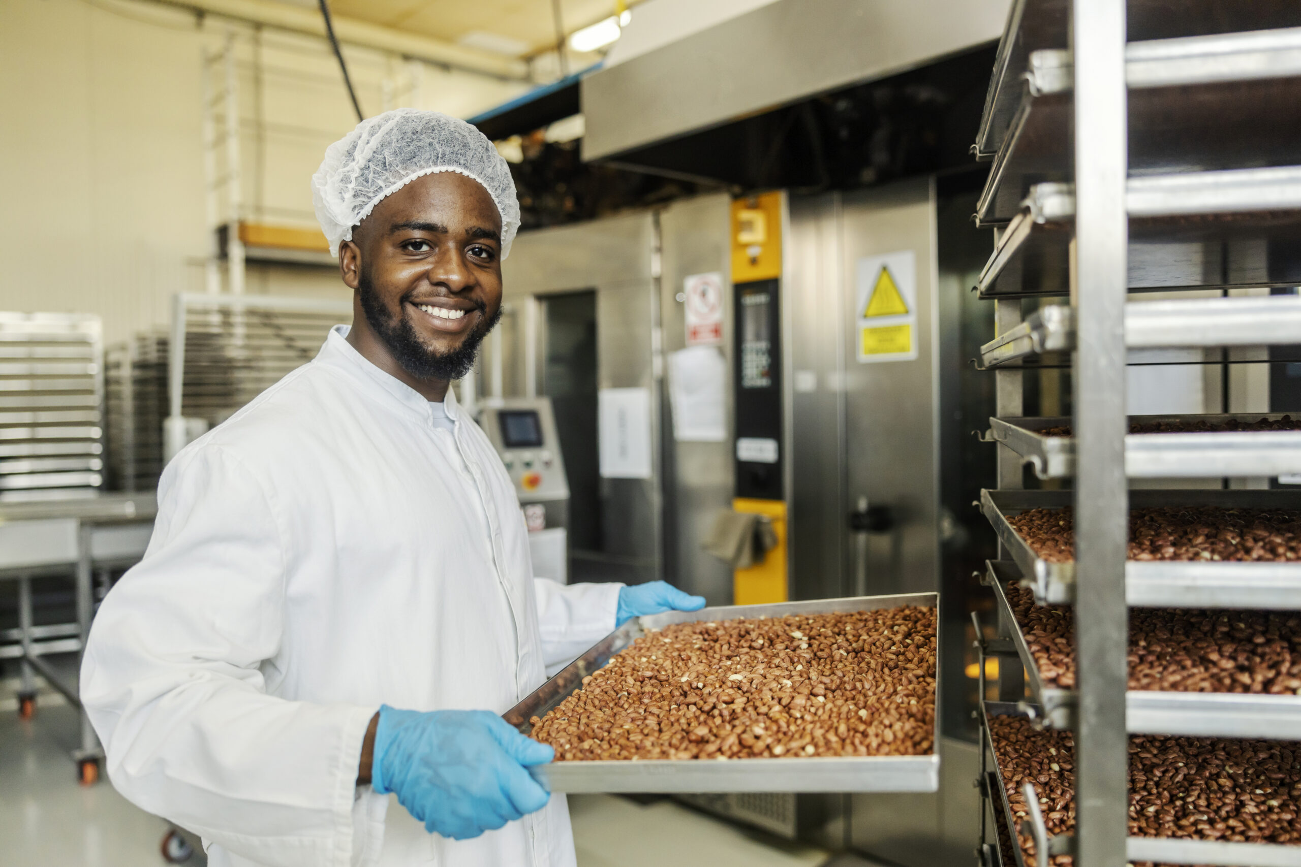 Portrait of happy multicultural food plant worker