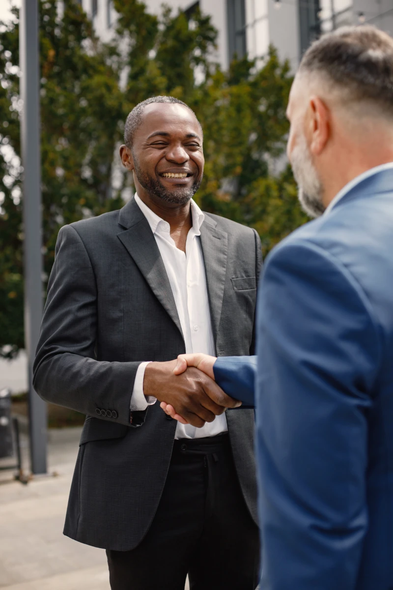 a man shaking hands with his partner